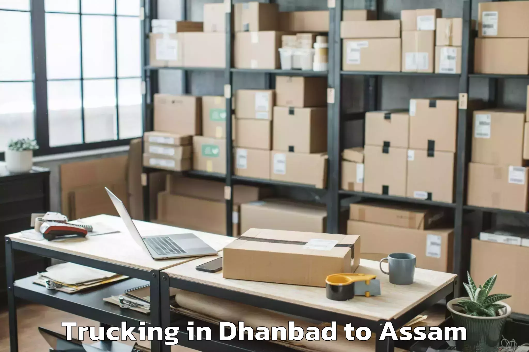 Dhanbad to Marigaon Trucking Booking